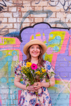 Portrait of me with flowers in front of a beautiful wall art