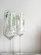 Personalized champagne flute featuring bridesmaid's name and hand-painted wedding bouquet design—elegant wedding party favor and keepsake.