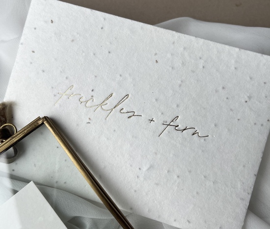 Hot foil Freckles & fern logo onto seeded card