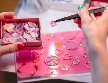 Close-up of my hands creating the jewelry