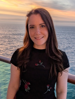 Image of a girl with brown hair, smiling for the camera.