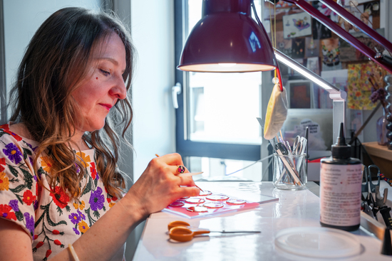 Me at my desk creating my jewellery in my workshop.