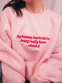 Model wearing pink My Tummy Hurts sweatshirt