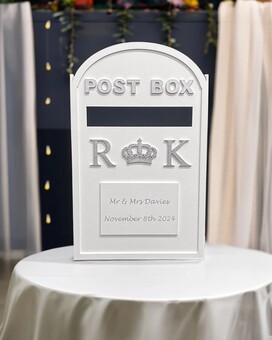 wedding card post box which has been personalised with the couple's initials names and wedding date the postbox is white and silver